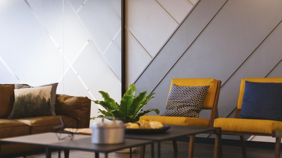 A suite sitting room with a sofa and armchairs